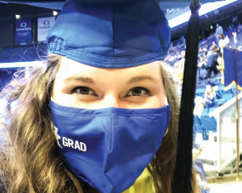 close up of woman wearing graduation cap with matching mask